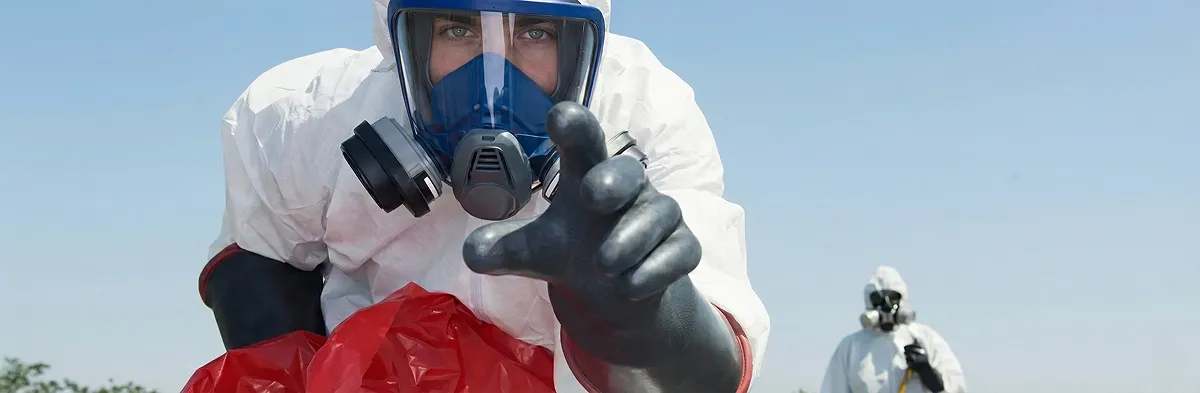 sewage clean up technician wearing protective gear handling biohazard materials in Evansville, IN